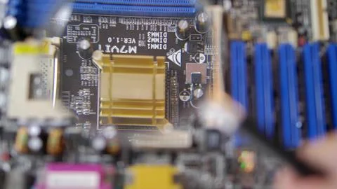 Computer Circuit Board with Electronic Chips under Magnifying Glass 写真素材