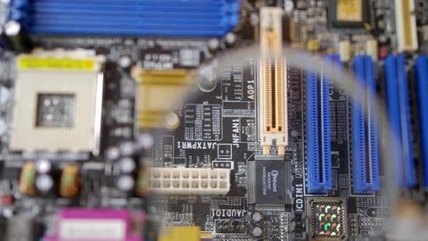 Computer Circuit Board with Electronic Chips under Magnifying Glass 写真素材