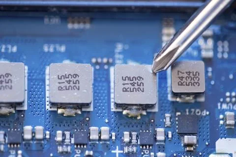 Computer circuit board, hand and screwdriver: Technician is fixing a motherboard Stock Photos