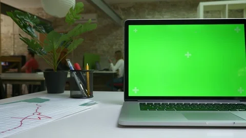 Computer with close-up green screen is on the white table in light office Stock Footage 97455918