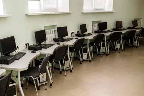 Computer Club, computer class with many PC, tables and chairs Stock Photos