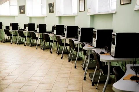 Computer Club, computer class with many PC, tables and chairs Stock Photos
