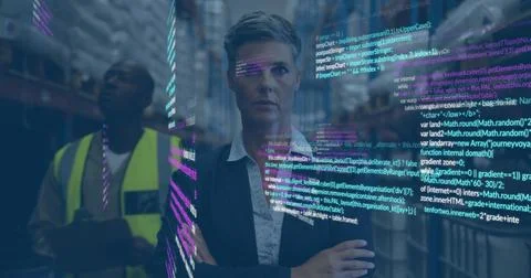 Computer code image over businesswoman in warehouse with worker in background Stock Photos