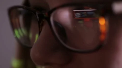 Computer Code Reflection in womans Glasses Browsing in dark. Internet Addiction Video stock 69806391