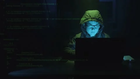 Computer Code Superimposed Over Male Kid Hacker At Work On A Laptop Stock Footage 166496485