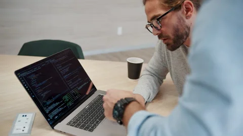 Computer coding: Business men working on a software design in an office Stock Footage 245637883