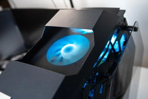 Computer cooling fan with bright blue led light installed in an iron gaming.. 스톡 사진