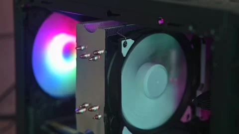 A computer cooling fan displays RGB lighting, showing various color patterns. 스톡 동영상 337112827