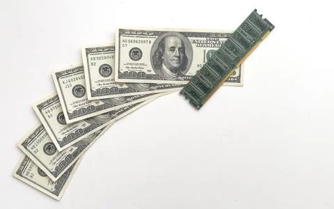 Computer CPU and memory chips on US dollar banknotes background. The high cost 스톡 사진
