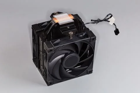 Computer CPU heatsink with two fans on a gray background Stock Photos