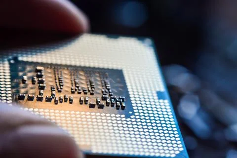 Computer CPU processor micro chip between fingers close up 스톡 사진