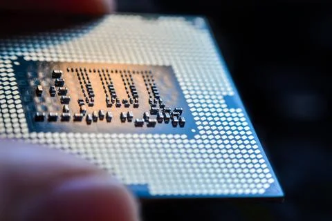 Computer CPU processor micro chip between fingers close up 写真素材