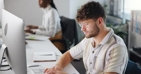 Computer, creative and typing with business man at work for design, development Stock Photos