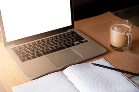 Computer, cup of coffee, notebook on the table Stock Photos
