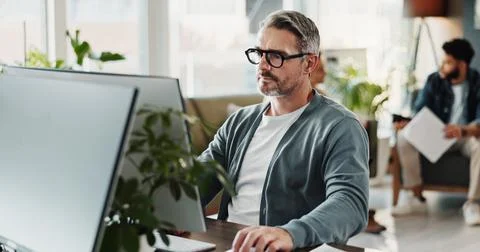 Computer, cybersecurity and programming with man in creative workplace for Stock-Fotos