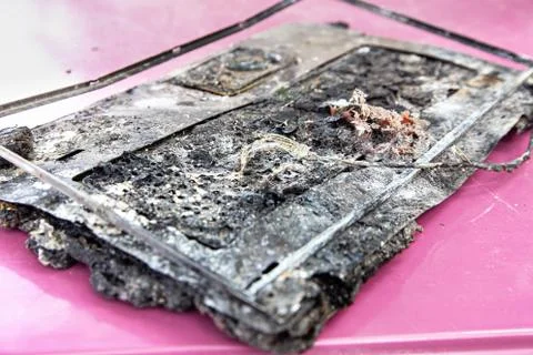 Computer damage, melted plastic. Laptop computer spoiled by flame of hot fire Stock Photos