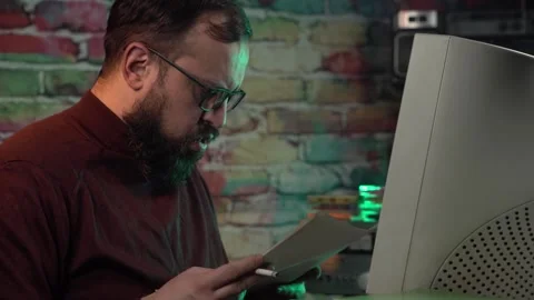 Computer Data Analyst From 1980's Looking in Paper Documents in Front of Stock Footage 306214968