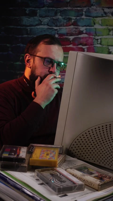 Computer Data Expert From 1980's Smoking Cigarette in Front of Desktop Computer Stock Footage 313578250
