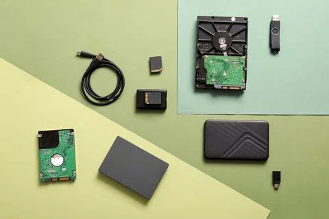 Computer data storage devices and components flat lay on green background for Stock Photos