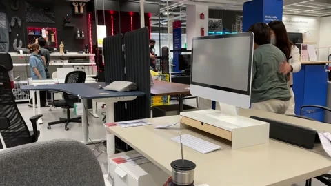 Computer desk and table design idea at IKEA Store. Shopper sit on office chair Stock Footage 172349598