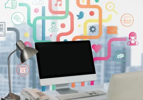 Computer on desk with apps against city window Stock Photos