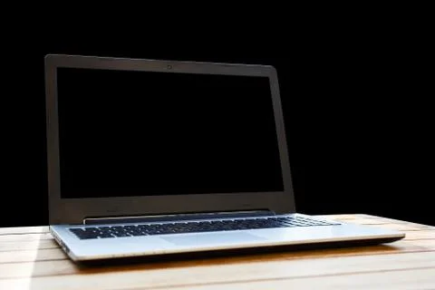 Computer on a desk on a black background. Stock Photos