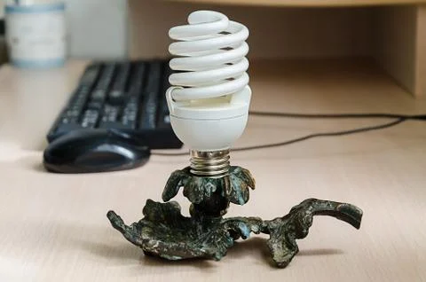 Computer desk with a keyboard and mouse and an unusual lamp Stock Photos