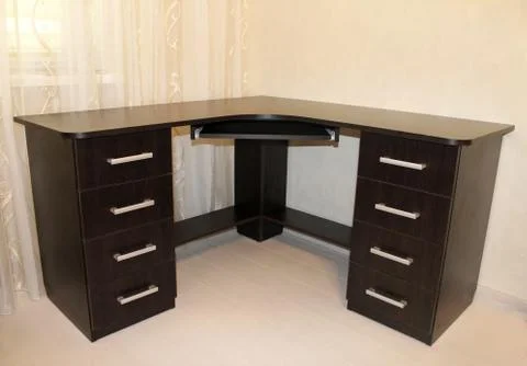 Computer Desk made of chipboard. Workplace in the interior of the room. Stock Photos