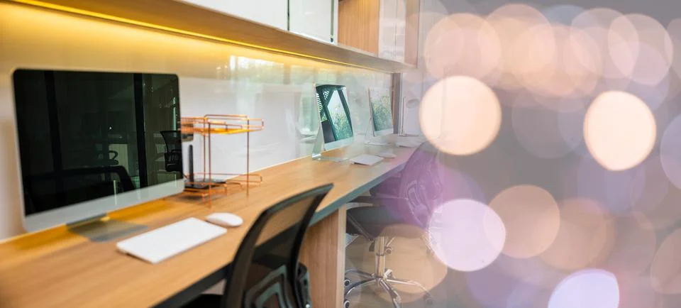 Computer desktop blank screen in front of window in office Stock Photos