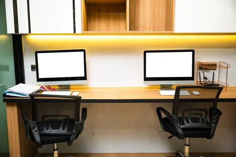 Computer desktop blank screen in front of window in office Stock Photos