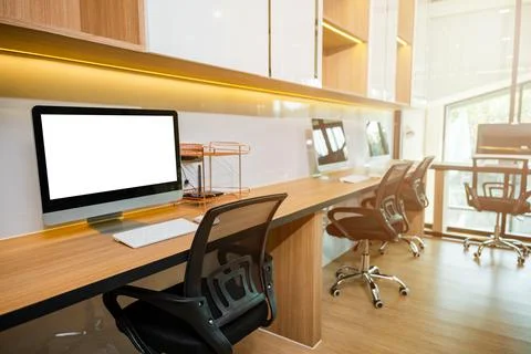 Computer desktop blank screen in front of window in office Stock Photos