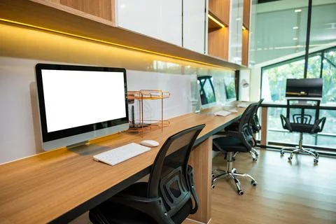 Computer desktop blank screen in front of window in office Stock Photos