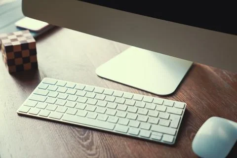 Computer on desktop in hipster workplace office - no people Stock Photos