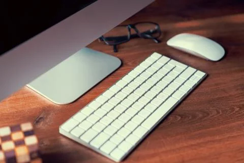 Computer on desktop in hipster workplace office - no people Stock Photos