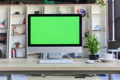 Computer desktop with mock-up green screen white background in office and Lov Stock Photos