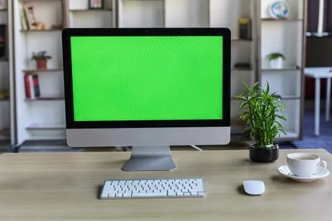 Computer desktop with mock-up green screen white background in office and Lov Stock Photos