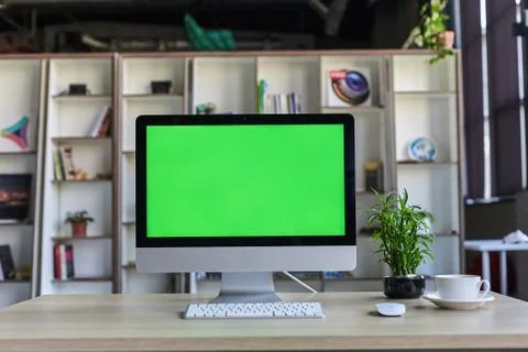 Computer desktop with mock-up green screen white background in office and Lov Stock Photos