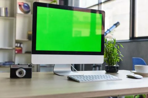 Computer desktop with mock-up green screen white background in office and Lov Stock Photos