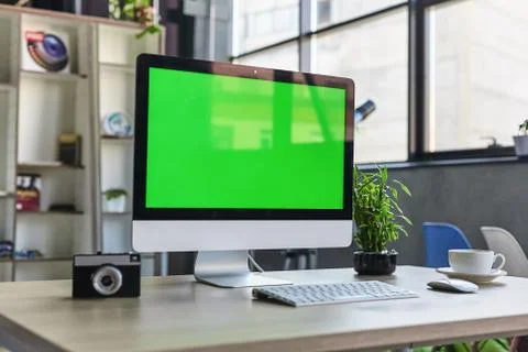 Computer desktop with mock-up green screen white background in office and Lov Stock Photos