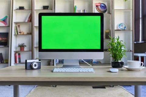 Computer desktop with mock-up green screen white background in office and Lov Stock Photos