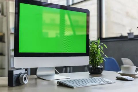 Computer desktop with mock-up green screen white background in office and Lov Stock Photos