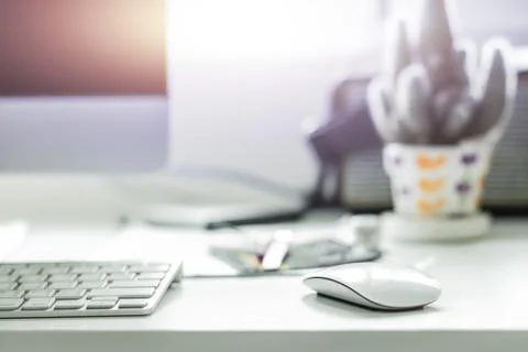 Computer desktop with white keyboard and mouse on working desk Stock Photos
