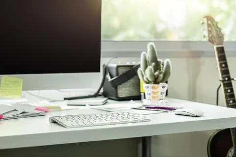 Computer desktop with white keyboard and mouse on working desk Stock Photos