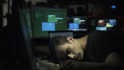Computer developer and hacker sleeping on his desk at night Stock Footage 92163063