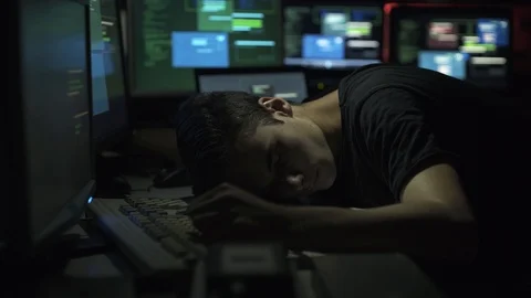 Computer developer and hacker sleeping on his desk at night Stock Footage 92163128