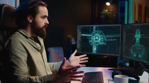 Computer developer confused by AGI AI turning autonomous, greeting him Stock Footage 266949730