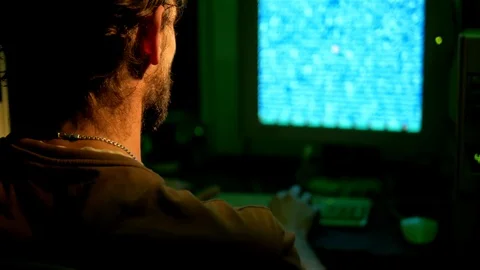 Computer developer works at home with database application on computer in dark r Video stock 95850648