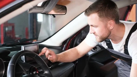 Computer diagnostics of correct operation of the car. A car mechanic in a Stock Footage 229957427