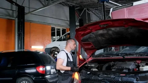 Computer diagnostics of trucks. Auto mechanic while working in a car service Stock Footage 255379539