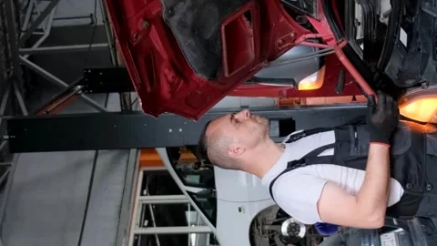 Computer diagnostics of trucks. Auto mechanic while working in a car service Stock Footage 259570442